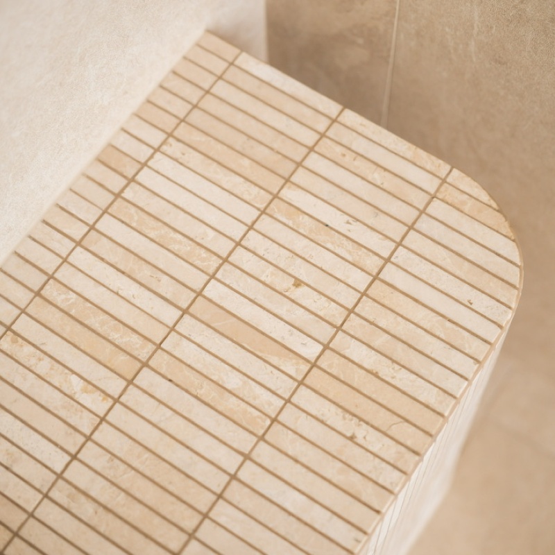 Detail of the travertine bench with fine fluted tiles