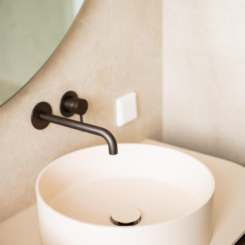 Den Haan Renovators craftsman adjusting the black shower tap